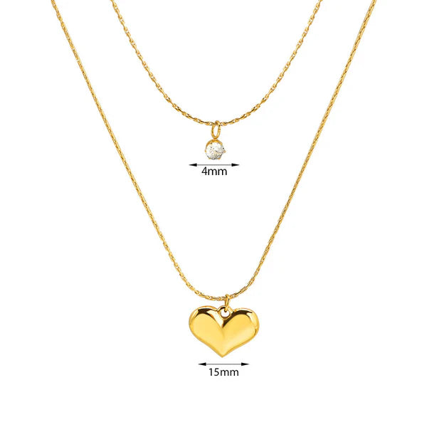 Gold necklaces with heart and round pendants on a white background