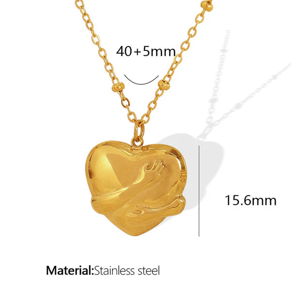 Gold heart-shaped pendant necklace with measurements and material information on a white background