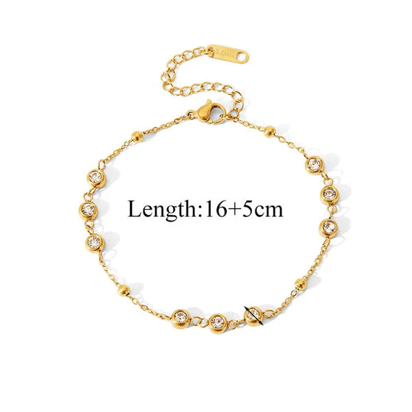 Gold bracelet with crystals on a white background