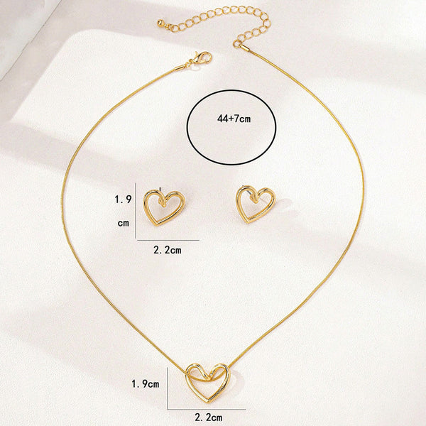 Gold heart-shaped necklace and earrings with measurements on a white background