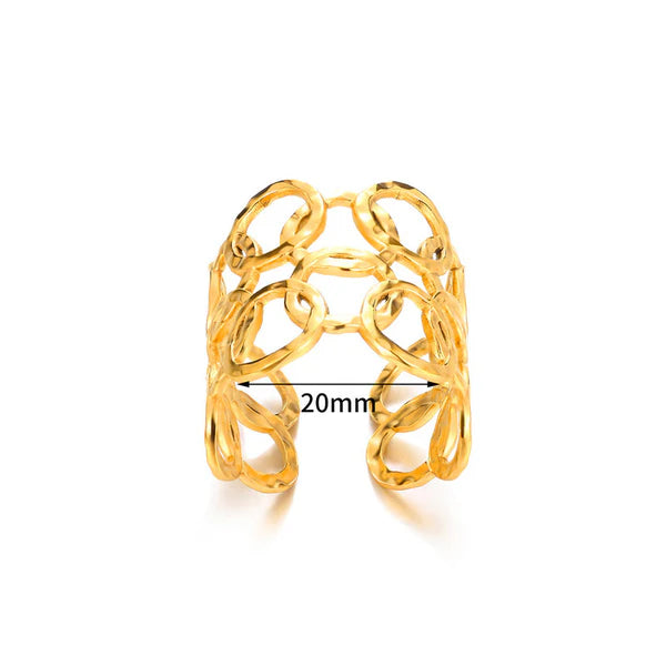 Gold ring with intricate design on a white background