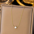 Gold necklace with a diamond pendant on a brown box