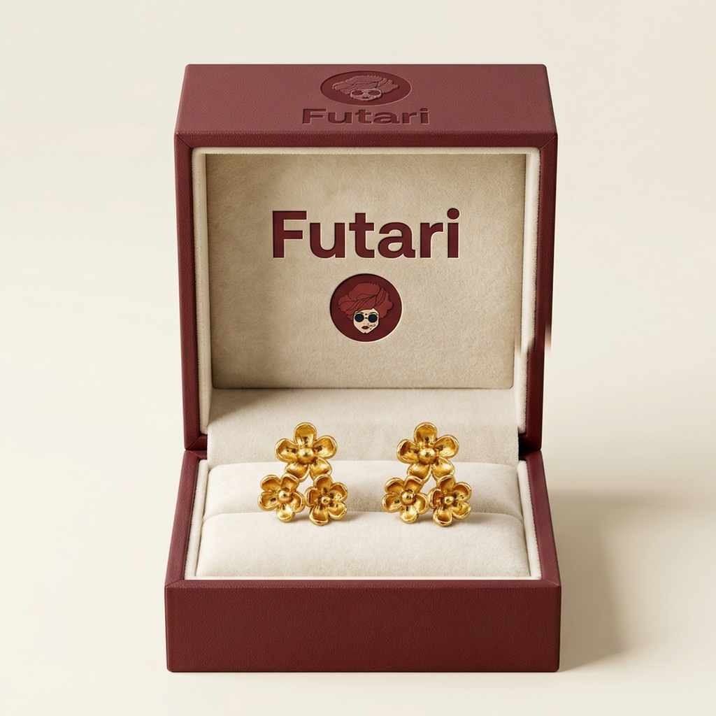 Gold earrings in an open 'Futari' jewelry box on a white background