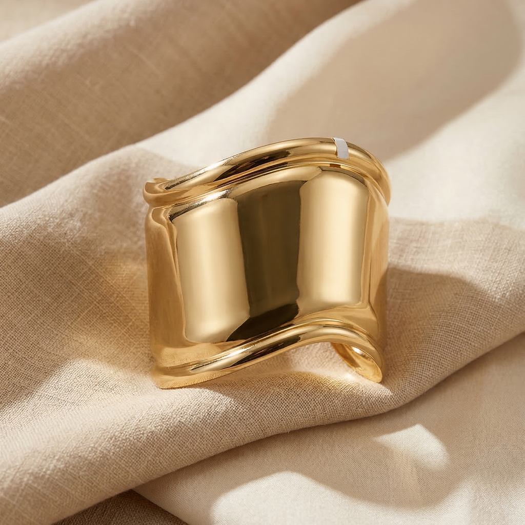 Gold ring on beige fabric