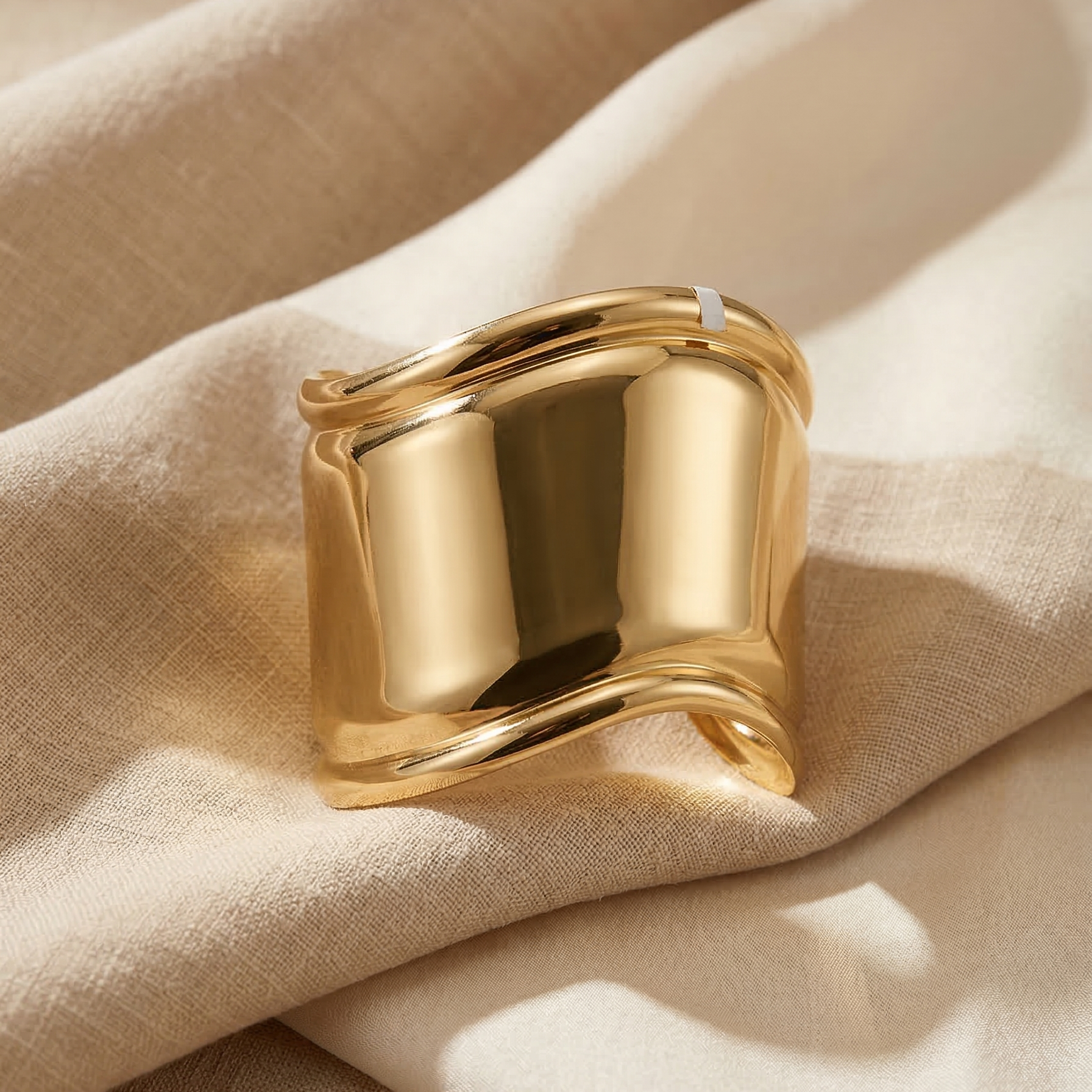 Gold ring on beige fabric
