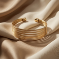 Gold bracelet on beige fabric