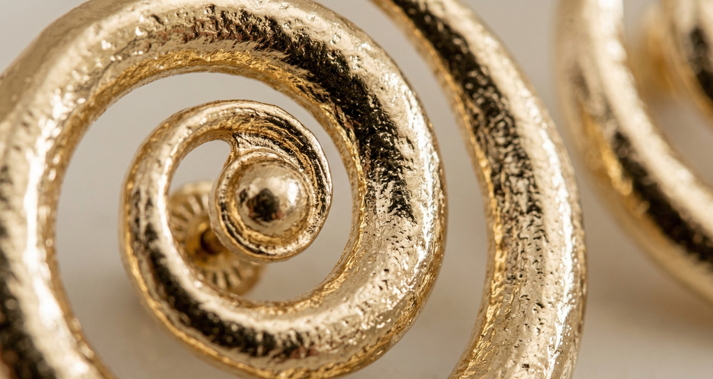 Close-up of a gold spiral design on a white background