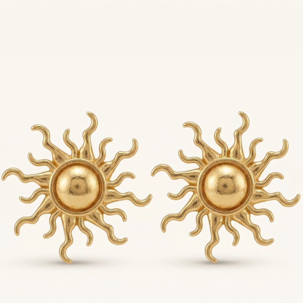 Pair of gold sun-shaped earrings on a white background