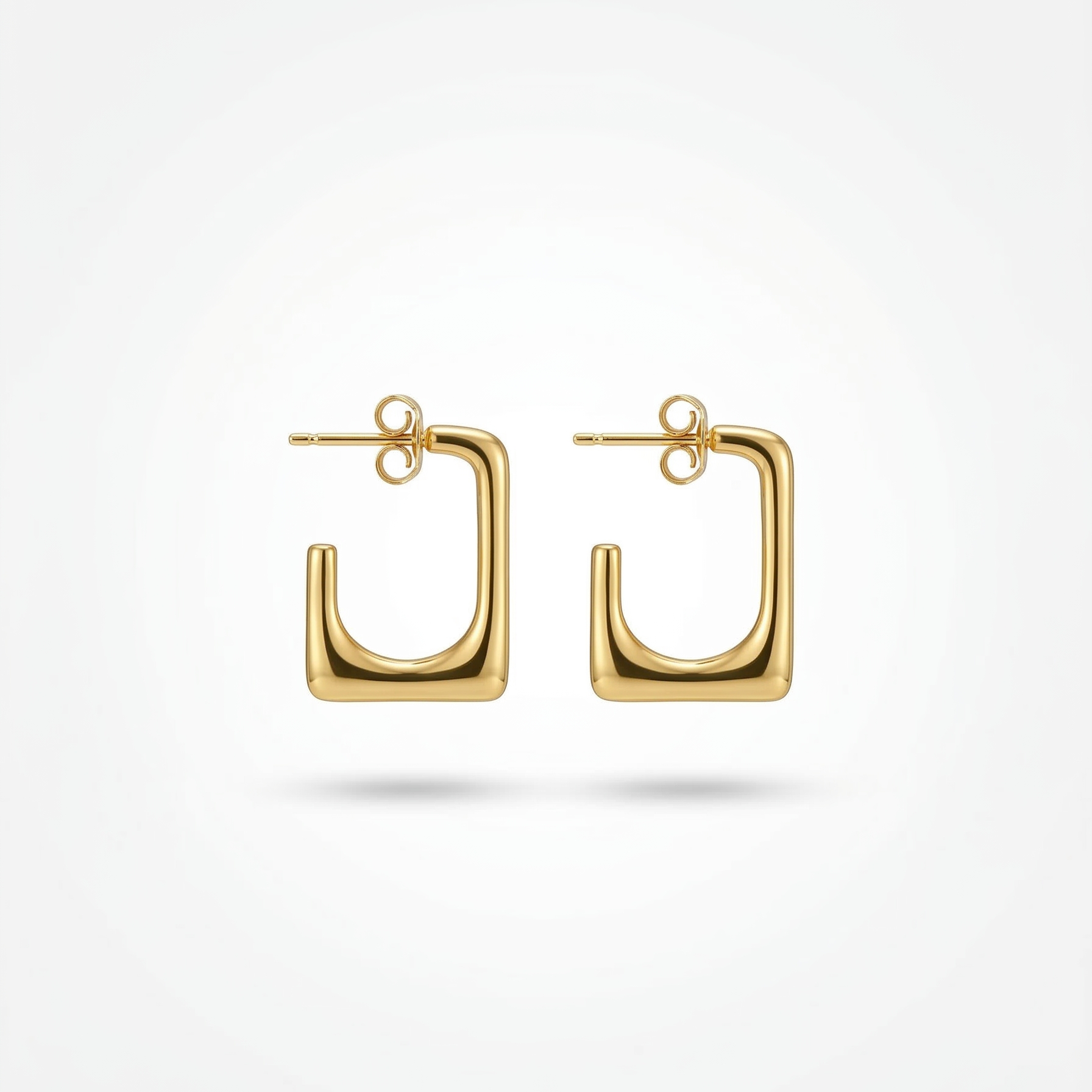 Gold hoop earrings on a white background