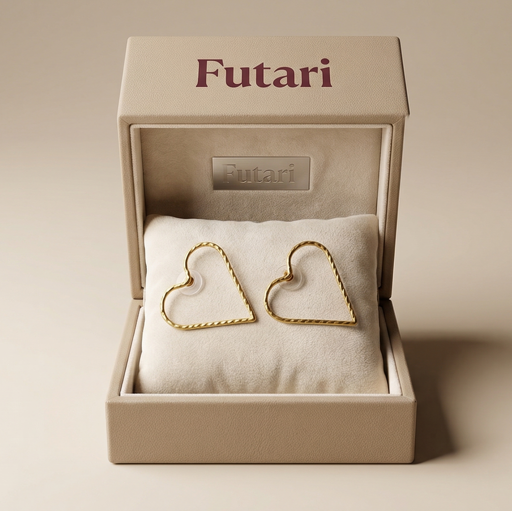 Heart-shaped gold earrings in a 'Futari' box on a beige background
