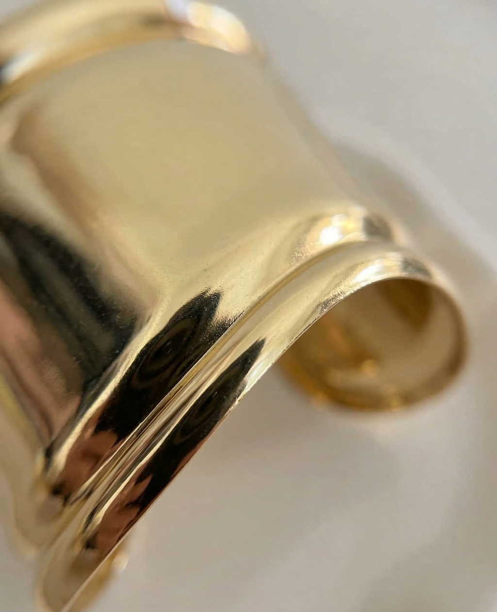 Gold bracelet on a white background