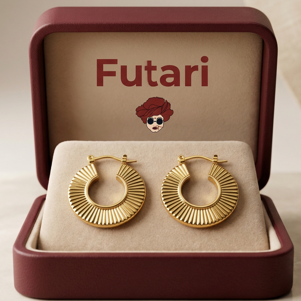 Gold hoop earrings in an open jewelry box with 'Futari' branding.