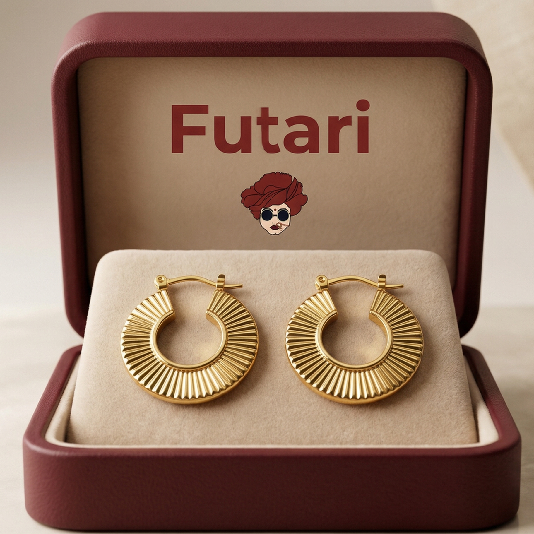 Gold hoop earrings in an open jewelry box with 'Futari' branding.