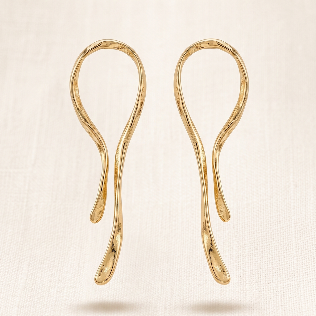 Pair of gold earrings on a beige background
