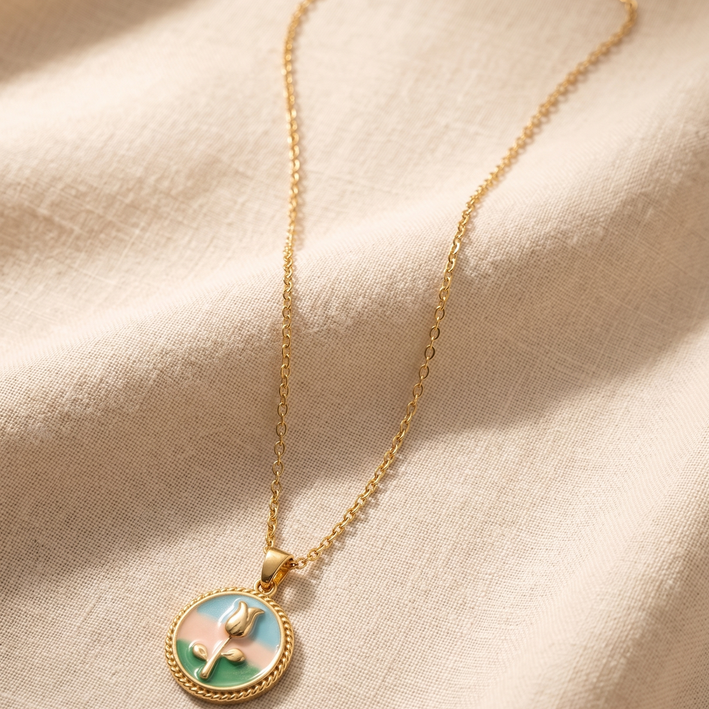 Gold necklace with a decorative pendant on a beige fabric background
