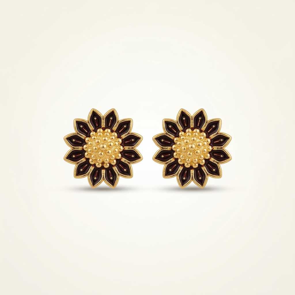 Pair of floral earrings with gold and black design on a beige background