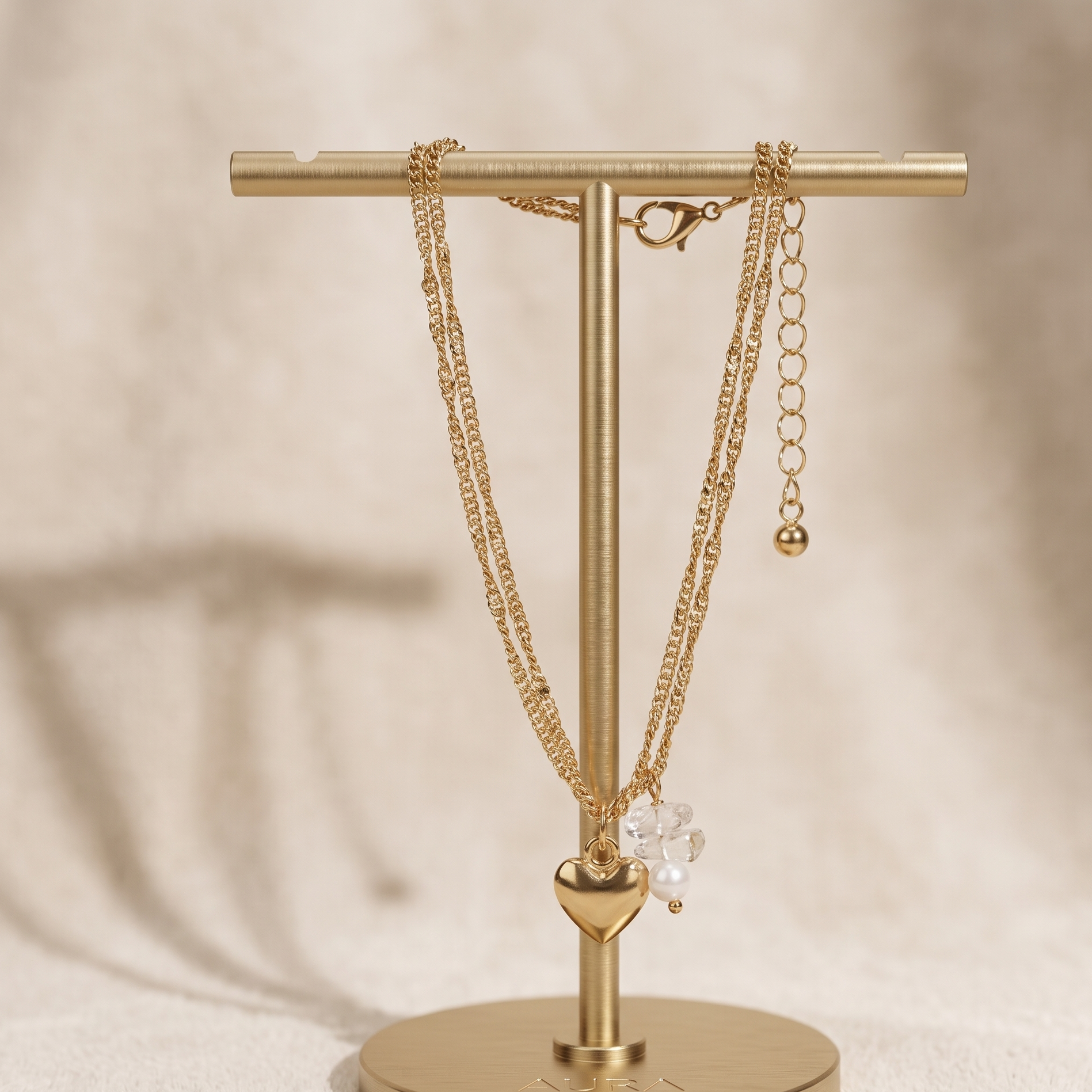 Gold necklace stand with gold chains on a beige background