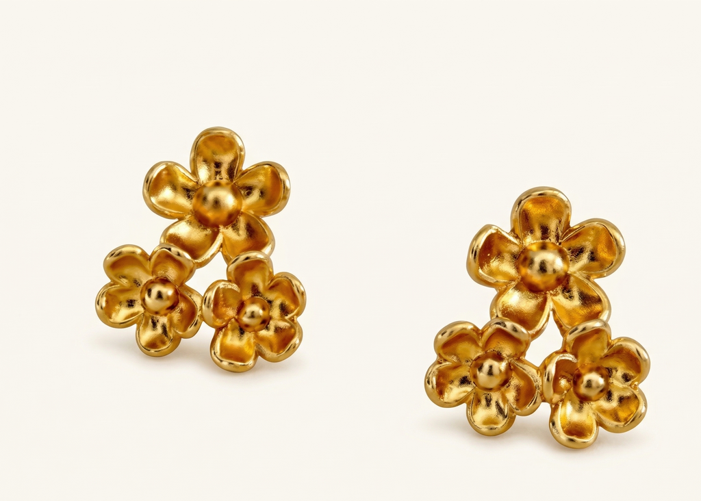 Pair of gold flower-shaped earrings on a white background