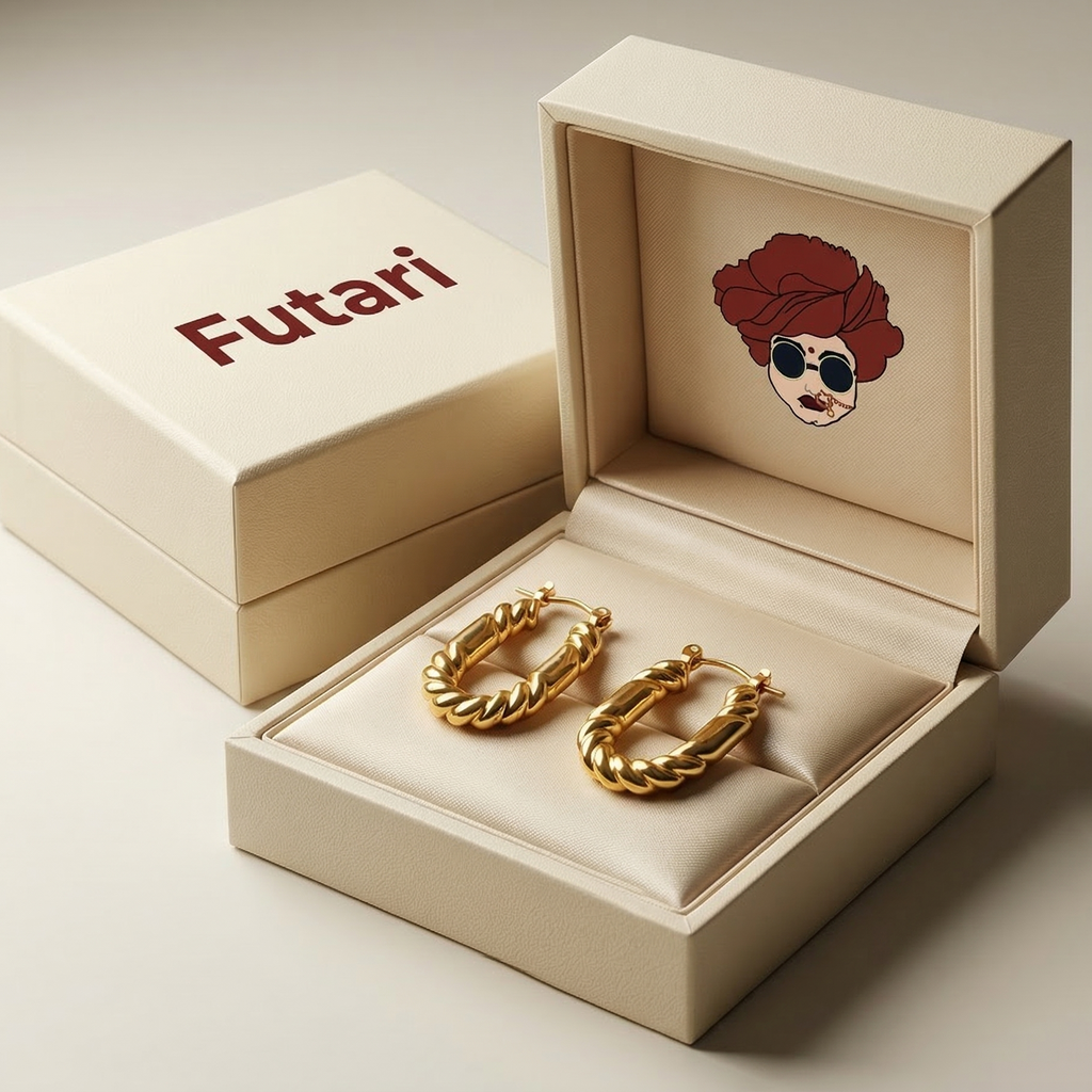 Gold hoop earrings in an open beige box with 'Futari' branding.