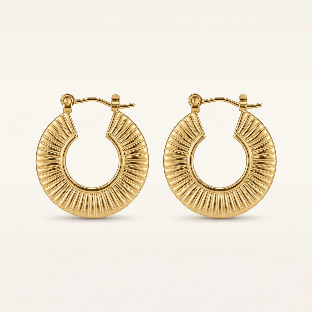 Gold hoop earrings on a light beige background