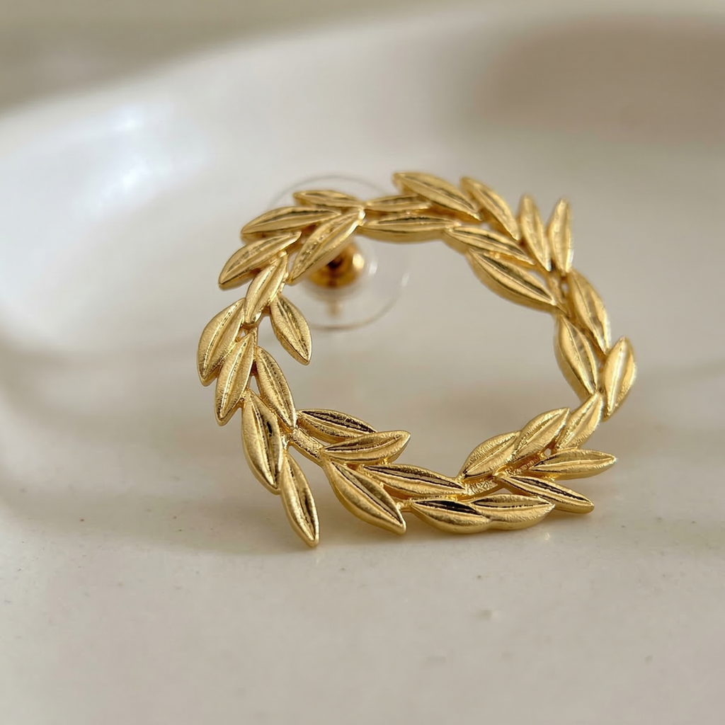 Gold leaf wreath earring on a white background