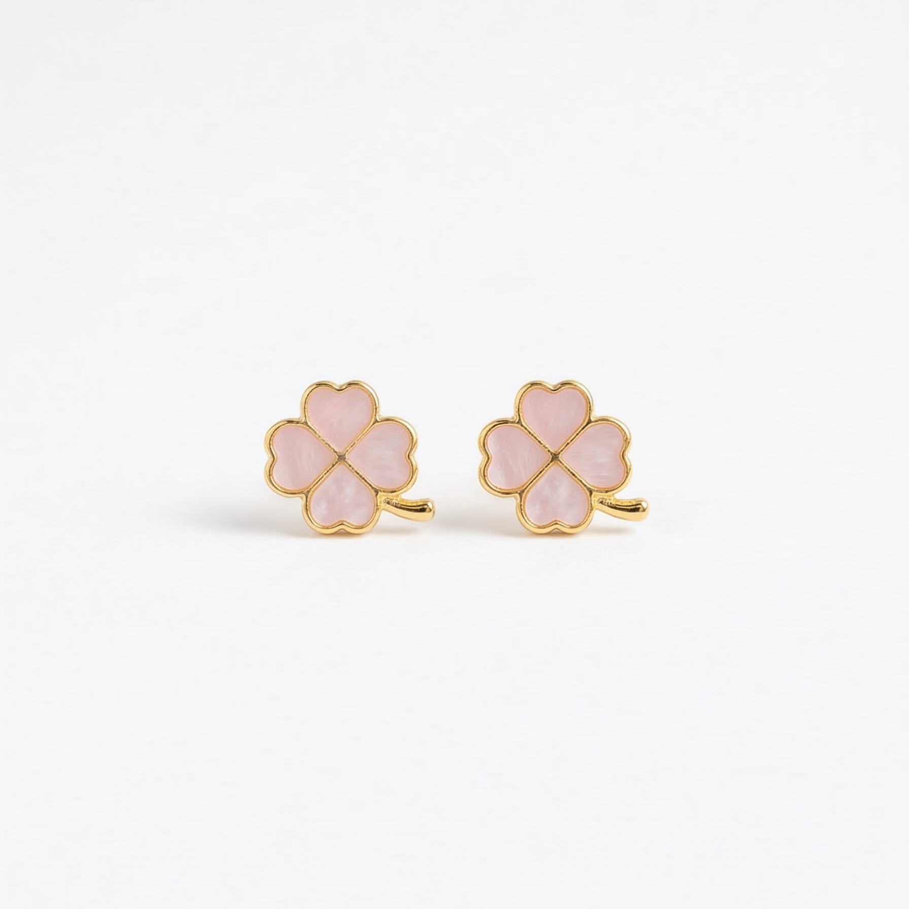 Pair of pink clover-shaped earrings with gold accents on a white background