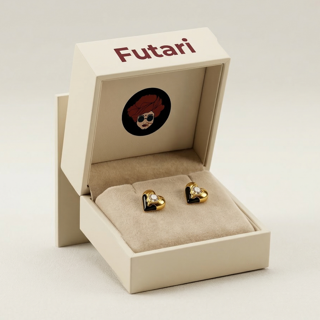 Gold heart-shaped earrings in an open beige box with 'Futari' branding on a light gray background.