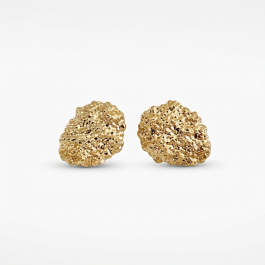 Pair of gold textured earrings on a white background