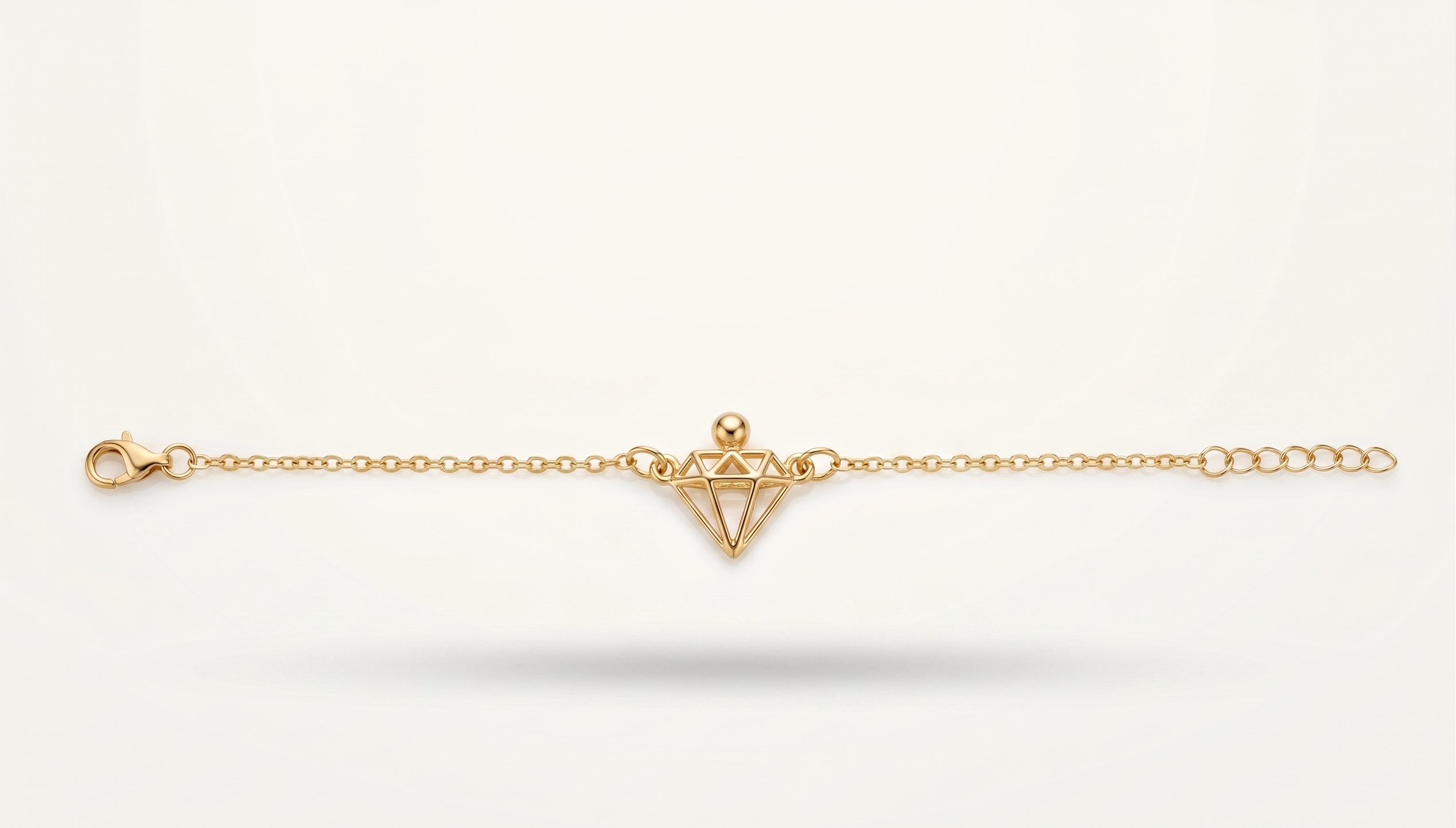 Gold bracelet with a geometric design on a white background