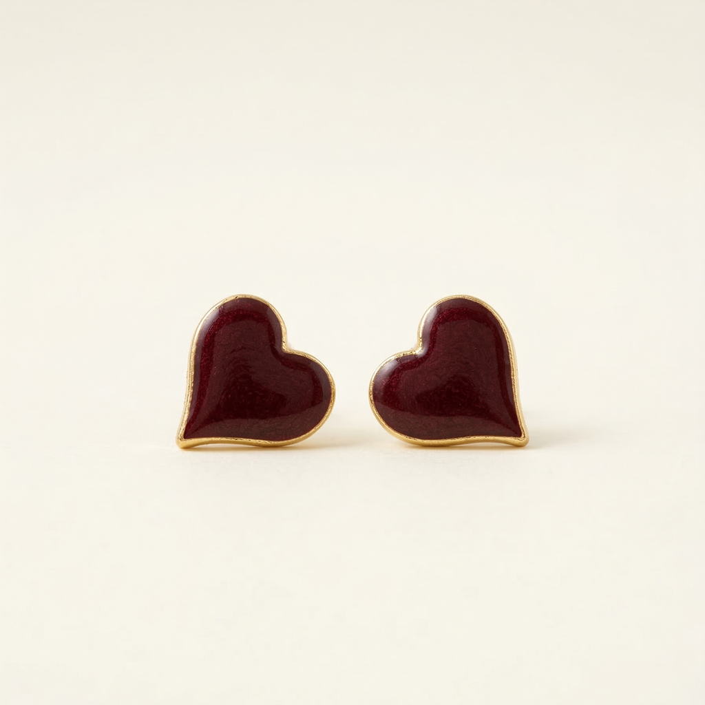 Heart-shaped earrings with gold rims on a beige background
