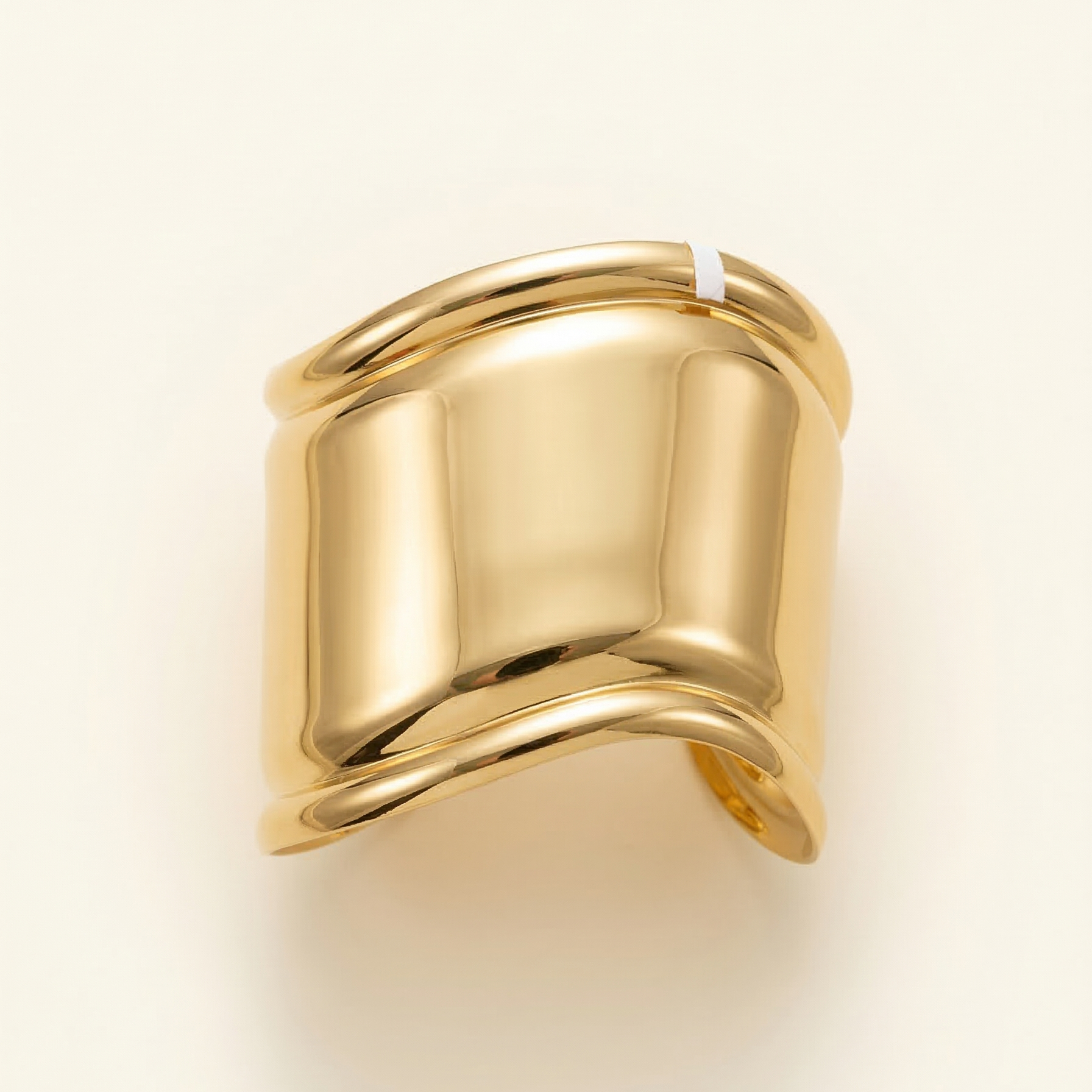 Gold ring on a light beige background