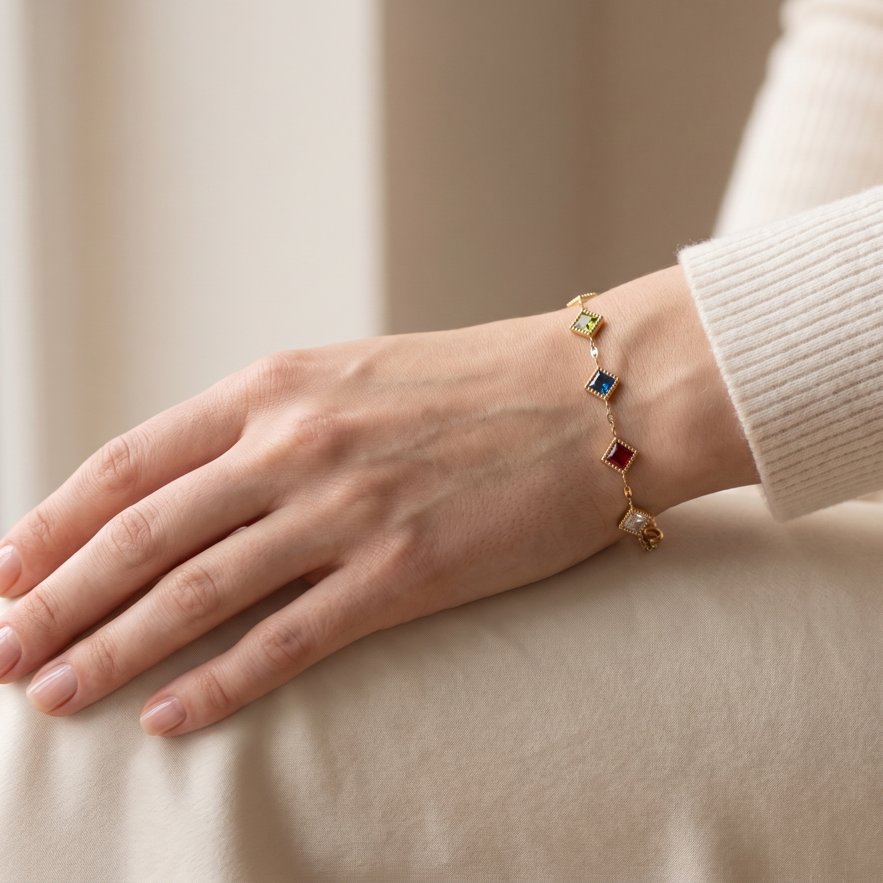 Hand wearing a colorful bracelet on a neutral background