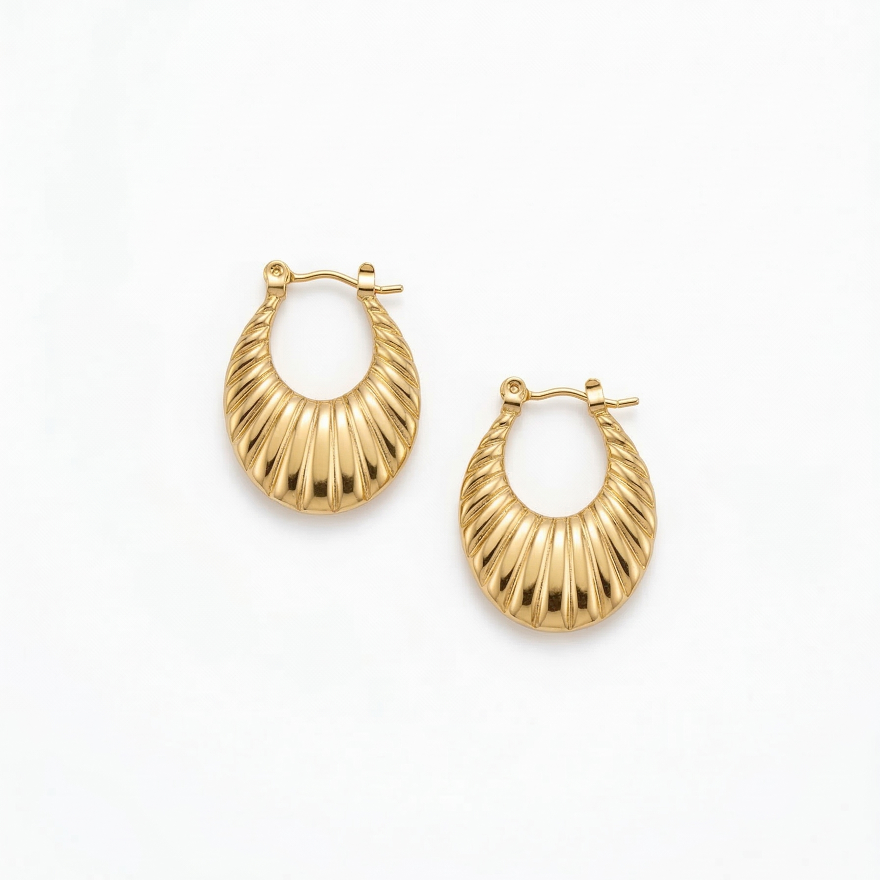 Gold hoop earrings on a white background