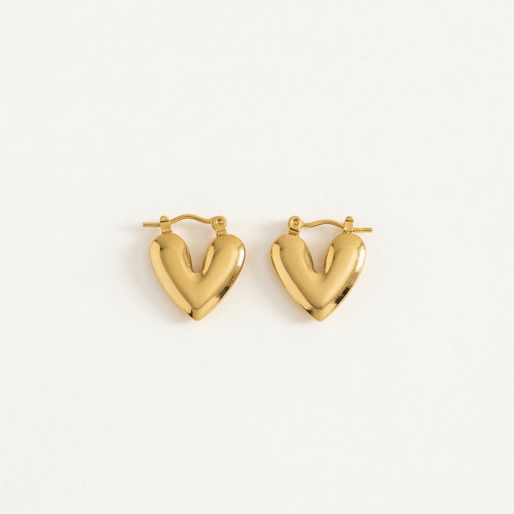 Gold heart-shaped earrings on a white background