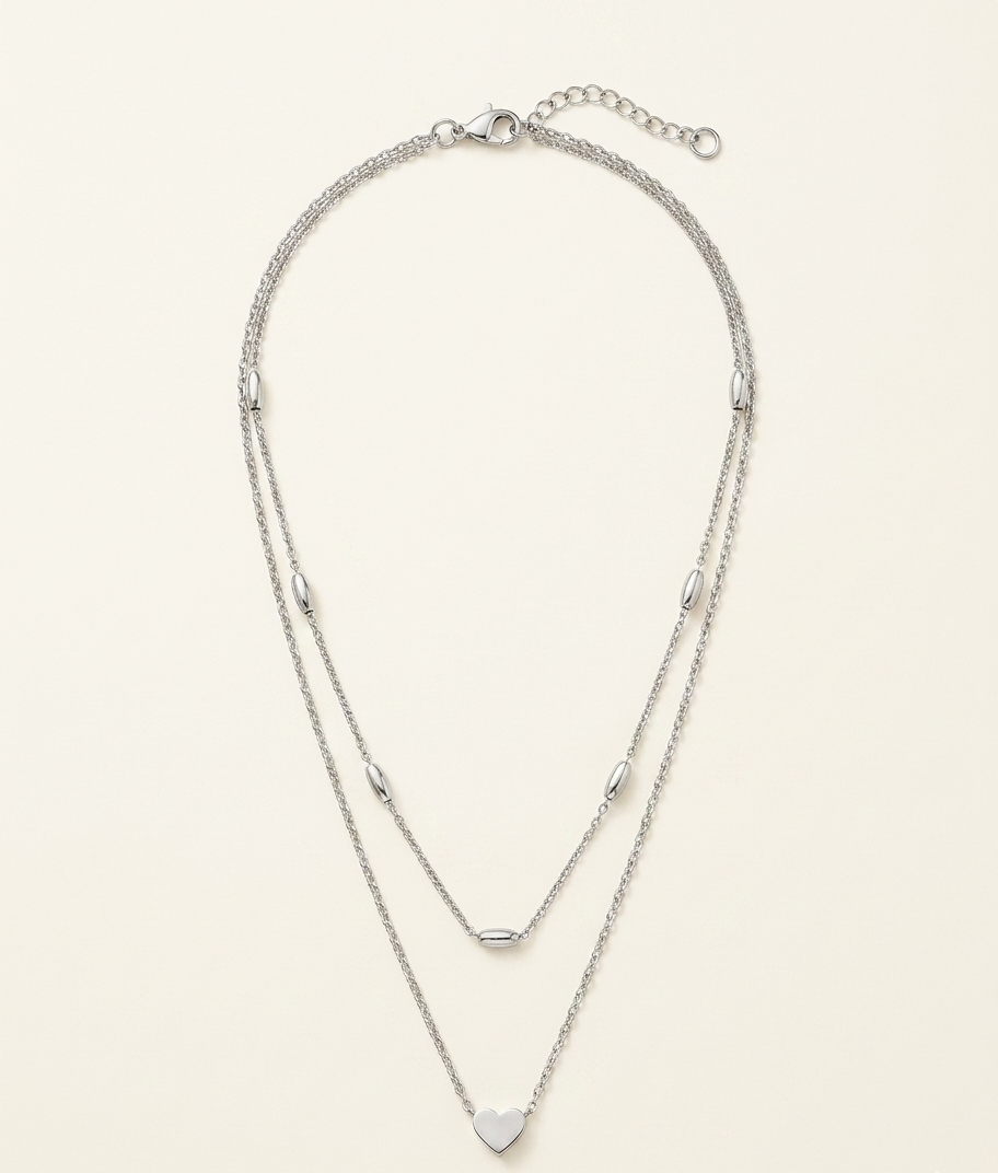 Silver necklace on a light beige background