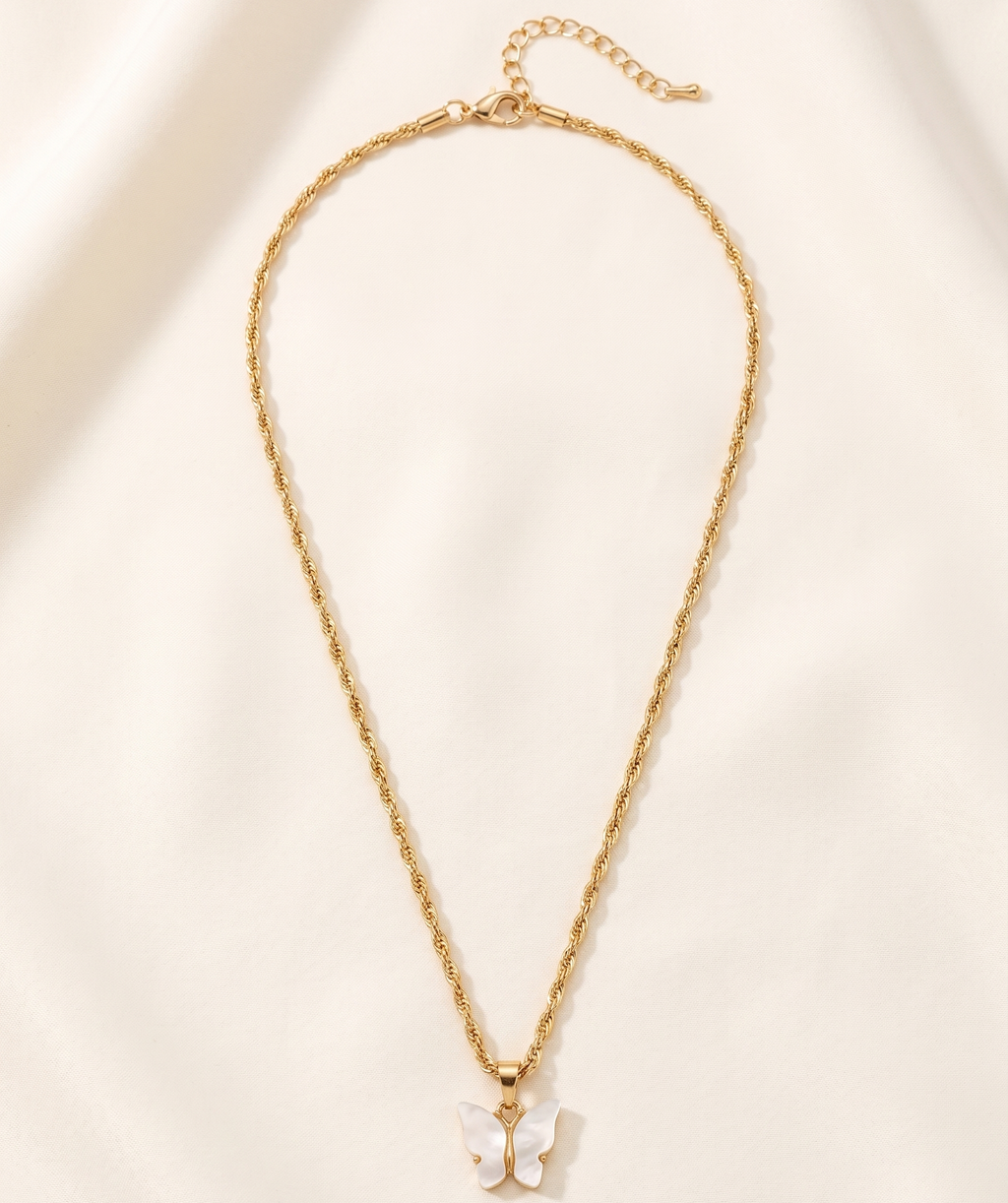 Gold necklace with a small pendant on a beige background