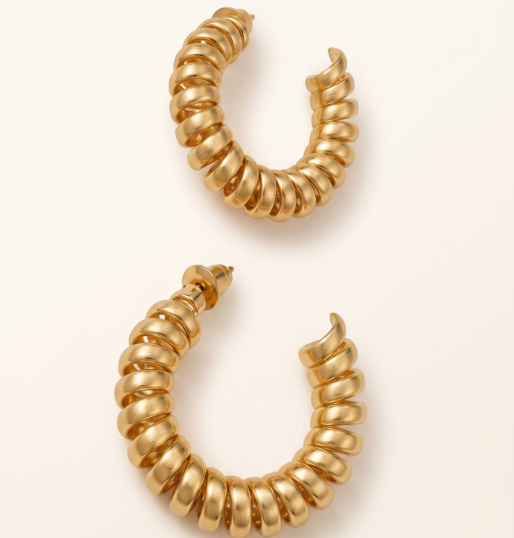 Pair of gold hoop earrings on a white background