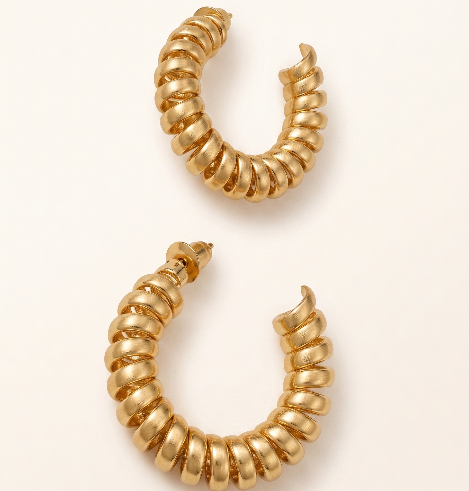Pair of gold hoop earrings on a white background