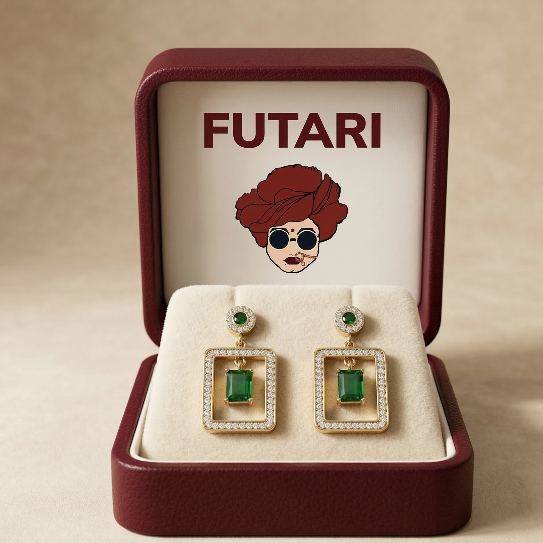Gold earrings with green gemstones in a 'FUTARI' branded box.