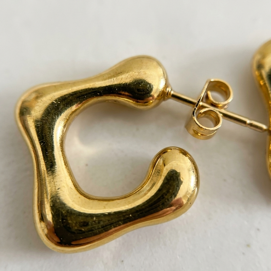 Gold hoop earrings on a light background