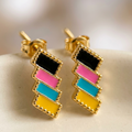 Colorful geometric earrings on a neutral background