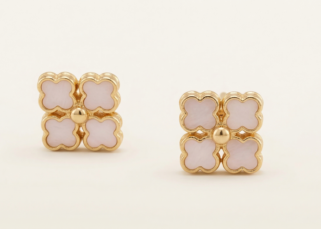Pair of gold and pink floral earrings on a white background