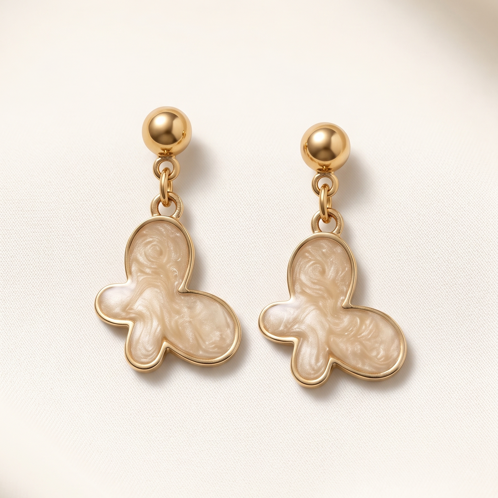 Gold gingerbread man earrings on a light beige background