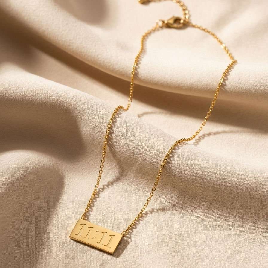 Gold necklace with a tag on a beige fabric background