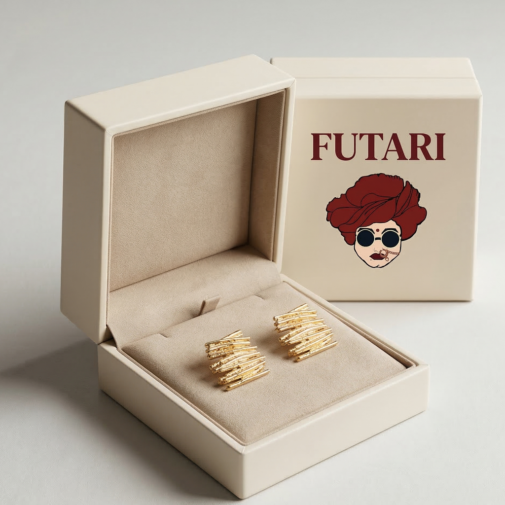 Gold earrings in an open beige box with 'FUTARI' branding on a light gray background
