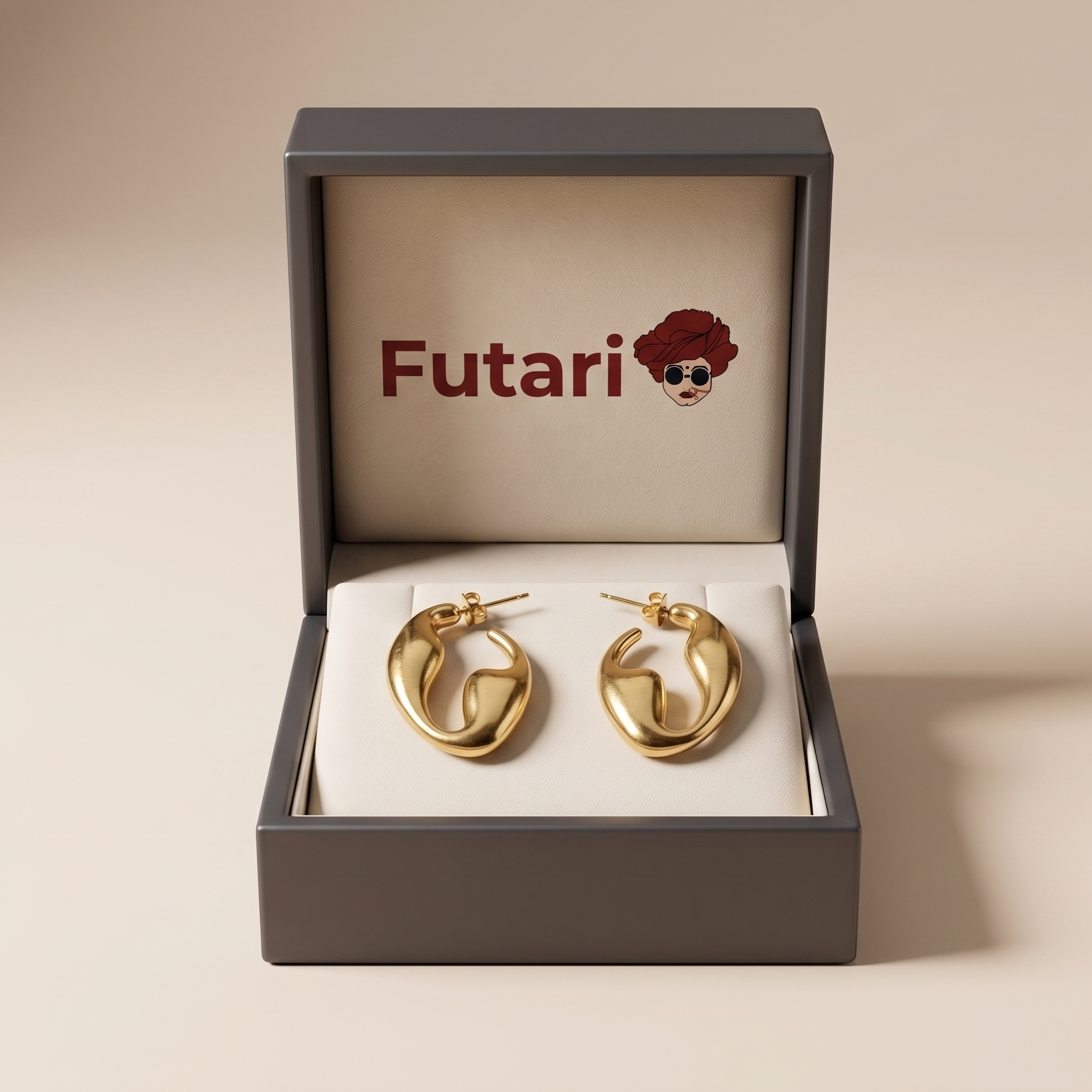 Gold earrings in a 'Futari' branded box on a beige background