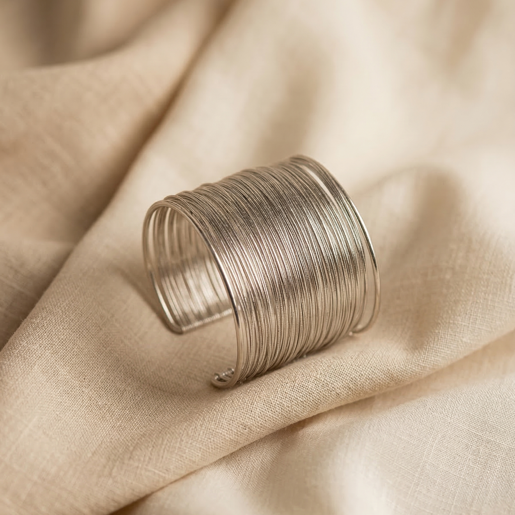 Silver ring on a beige fabric background