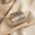 Silver ring on a beige fabric background