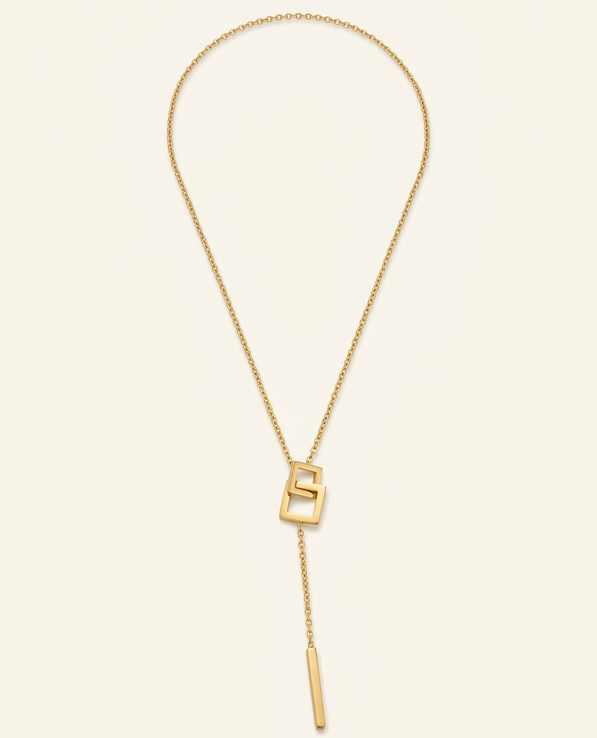 Gold necklace with a unique clasp on a beige background