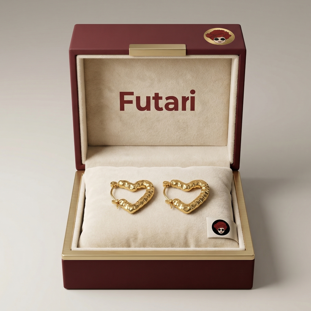 Gold heart-shaped earrings in a 'Futari' jewelry box on a light gray background